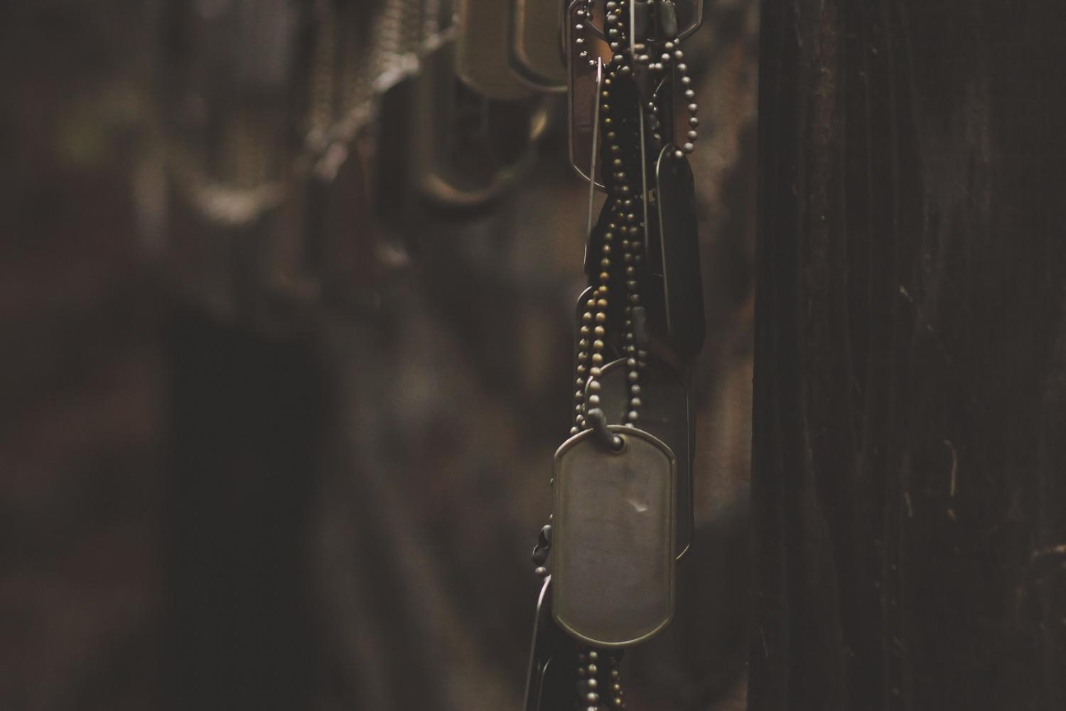 Dog tags hanging on a memorial