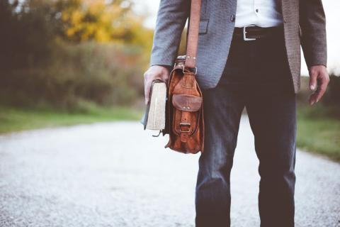 A Man with a Messenger Bag and a Book