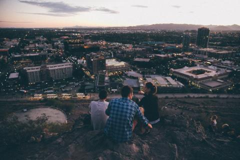 Students sitting on "A" Mountain in Tempe, overlooking ASU