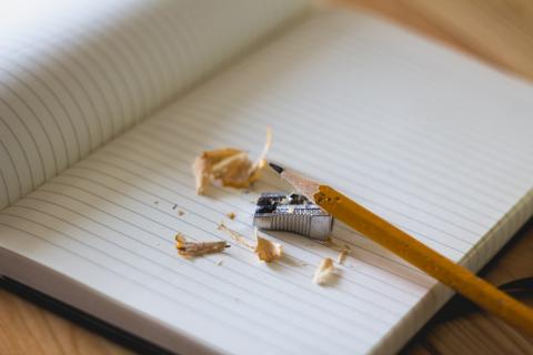 A pencil, sharpener, and notebook