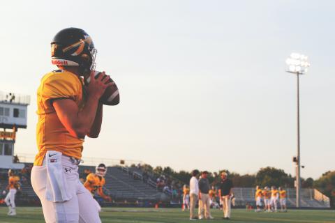 A quaterback preparing to throw in pre-game warmups