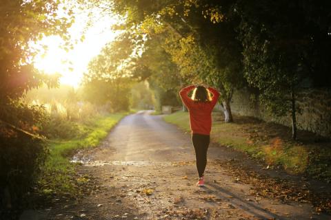 A woman on a morning run through a forest