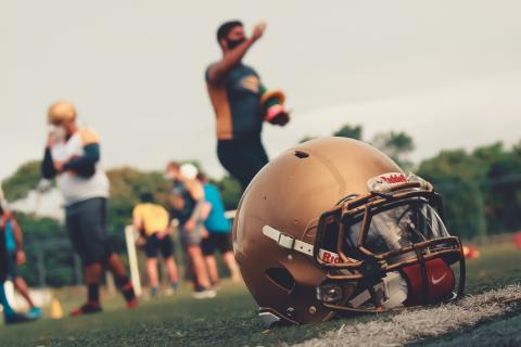 A football helmet in the grass during practice