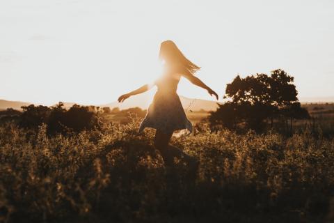 A woman dancing in a field