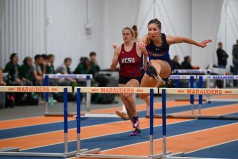 Athletes Jumping Hurdles